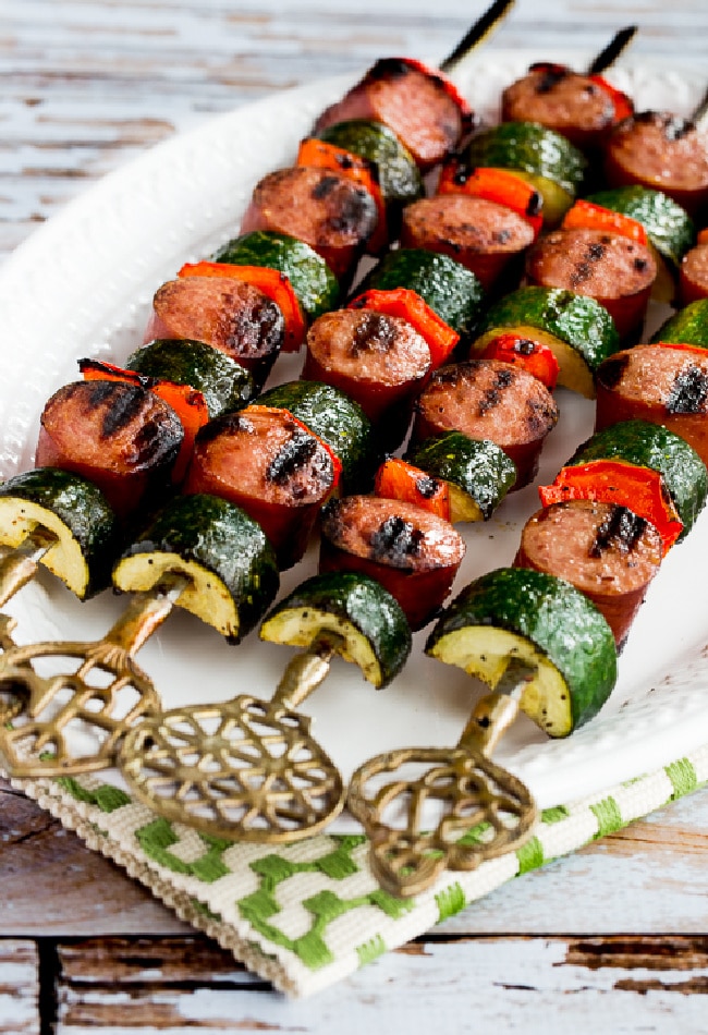 Easy Kabobs with Zucchini and Sausage shown on serving plate with napkin