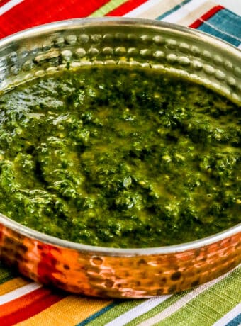 Square image for Chermoula Sauce shown in serving dish on striped napkin.