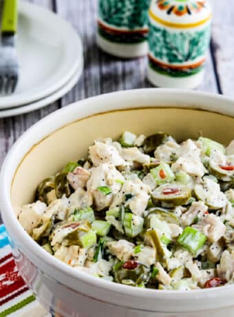 Square image of Chicken Salad with Green Olives shown in large serving bowl.