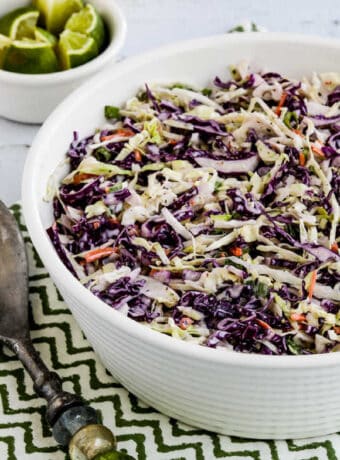 Spicy Lime Coleslaw in serving bowl on green-white napkin