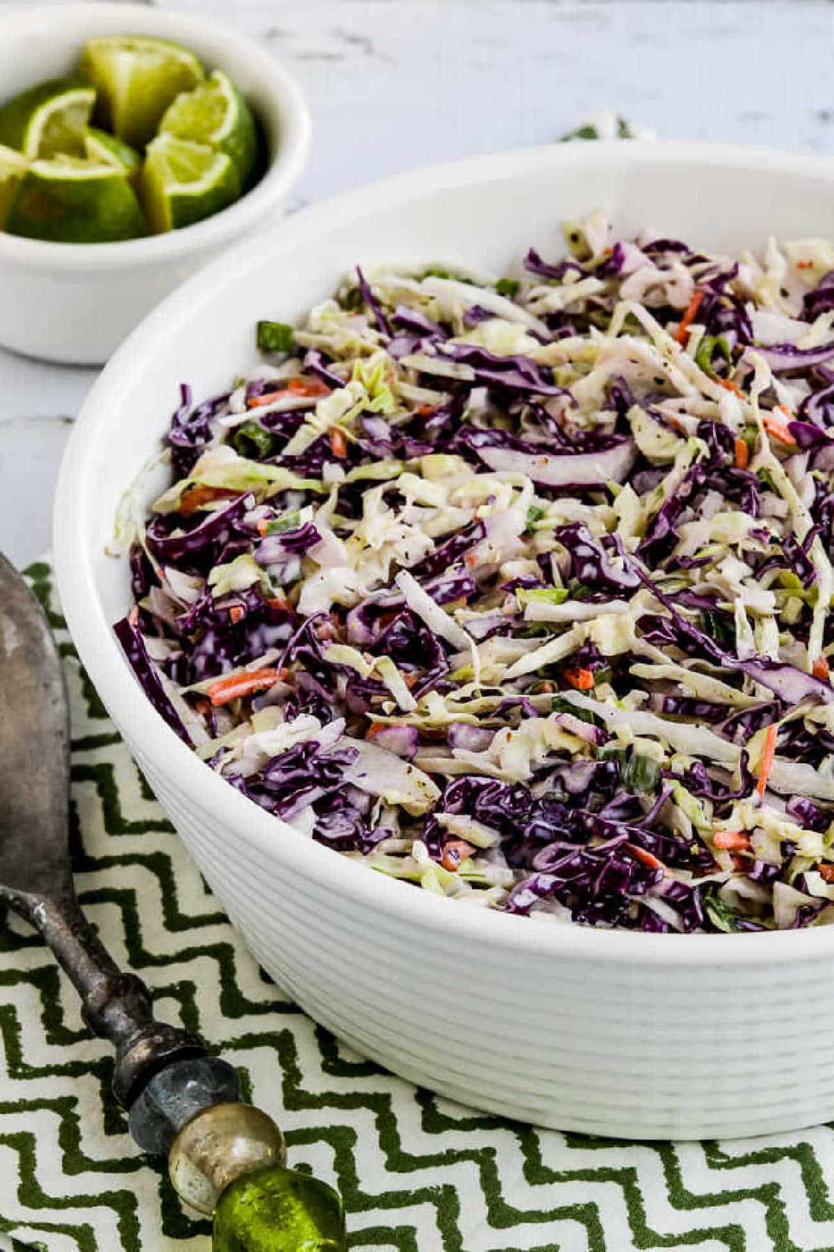 Spicy Lime Coleslaw in serving bowl on green-white napkin