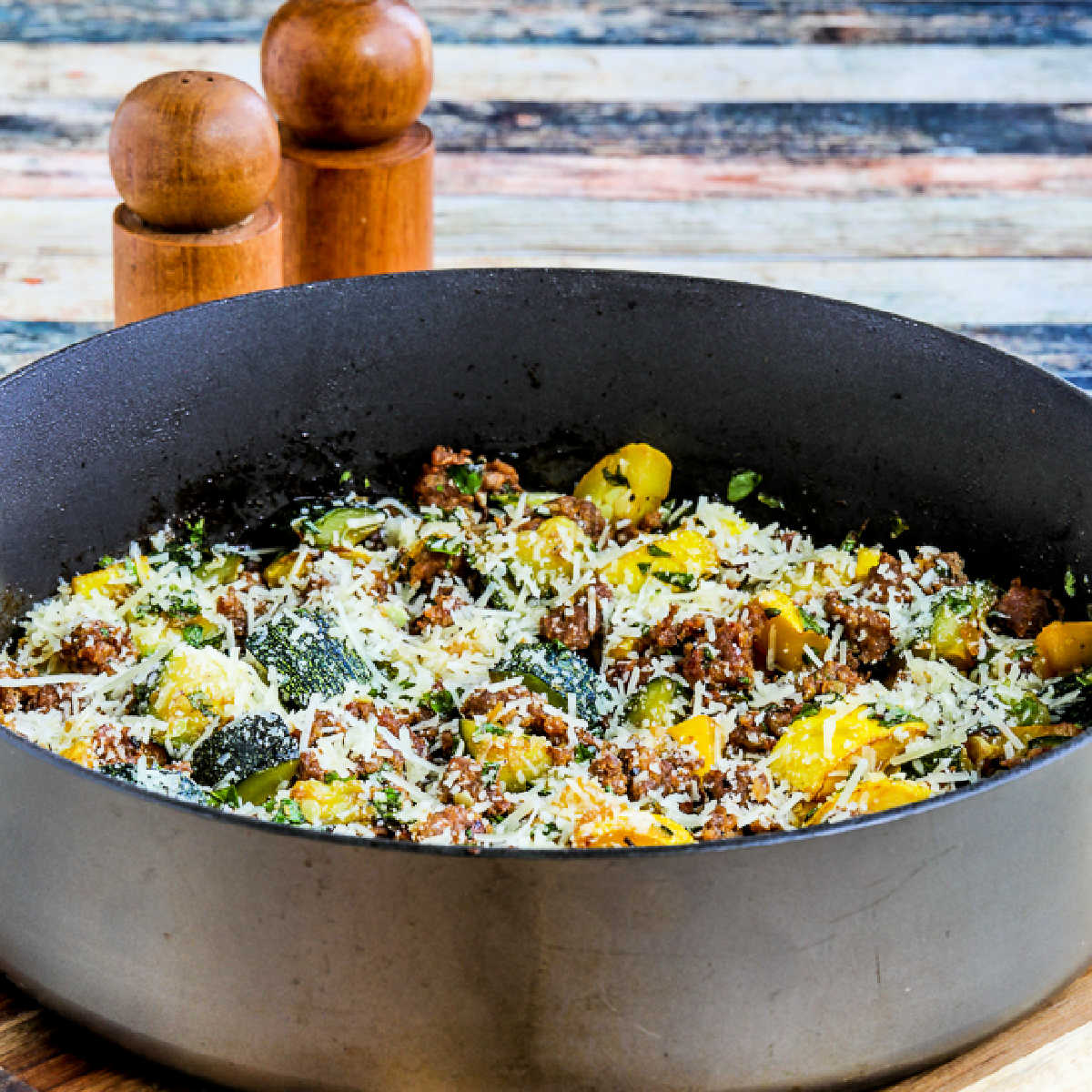 Square image for Italian Sausage and Zucchini Skillet meal shown in skillet.