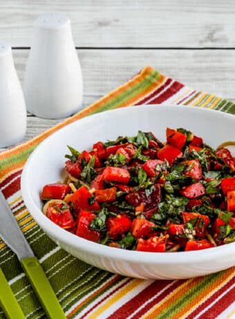Square image of Tomato Basil No-Cook Pasta Sauce shown in serving bowl with spaghetti.
