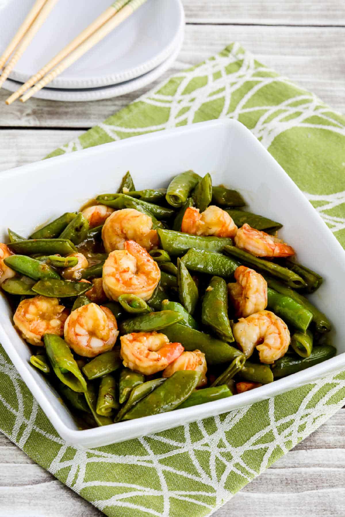 Stir-Fried Shrimp and Sugar Snap Peas in serving bowl on green-white napkin
