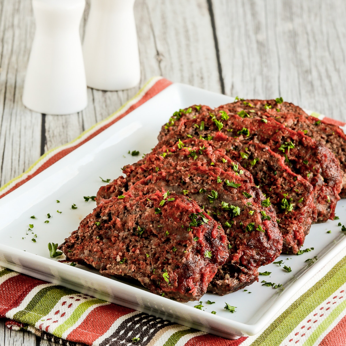 Square image of Beef and Sausage Italian Meatloaf on serving plate