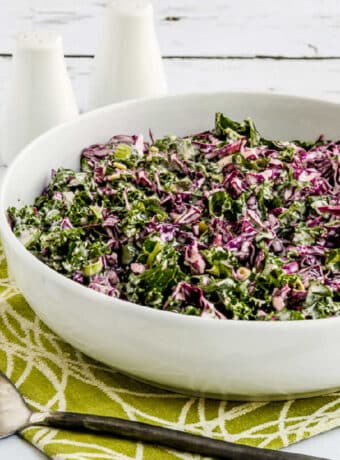 Kale and Red Cabbage Slaw in serving bowl with spoon.