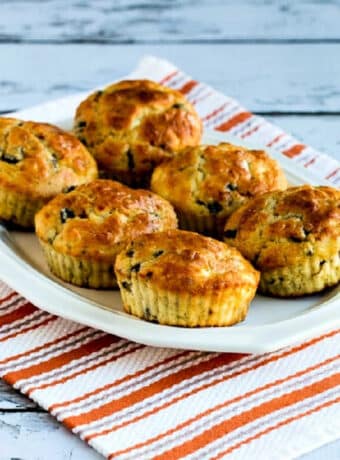Cottage Cheese Breakfast Muffins with Mushrooms and Feta with six muffins shown on serving platter.