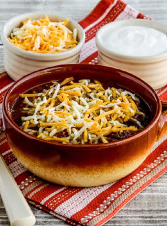 square image of Pumpkin Chili with Ground Beef with grated cheese