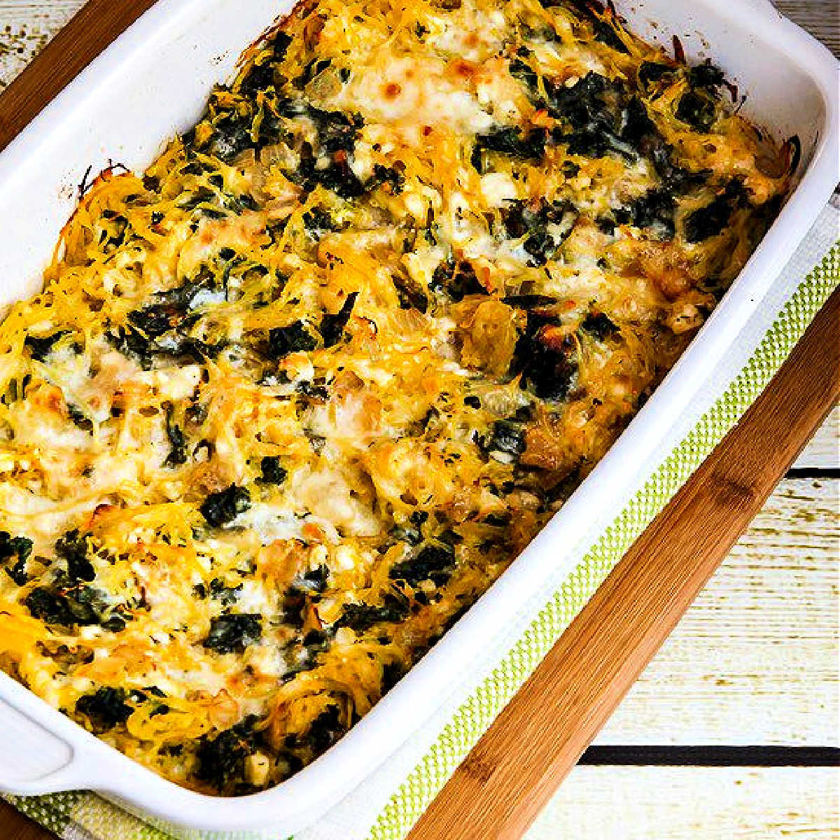 Square image for Twice-Baked Spaghetti Squash with Kale shown in baking dish.