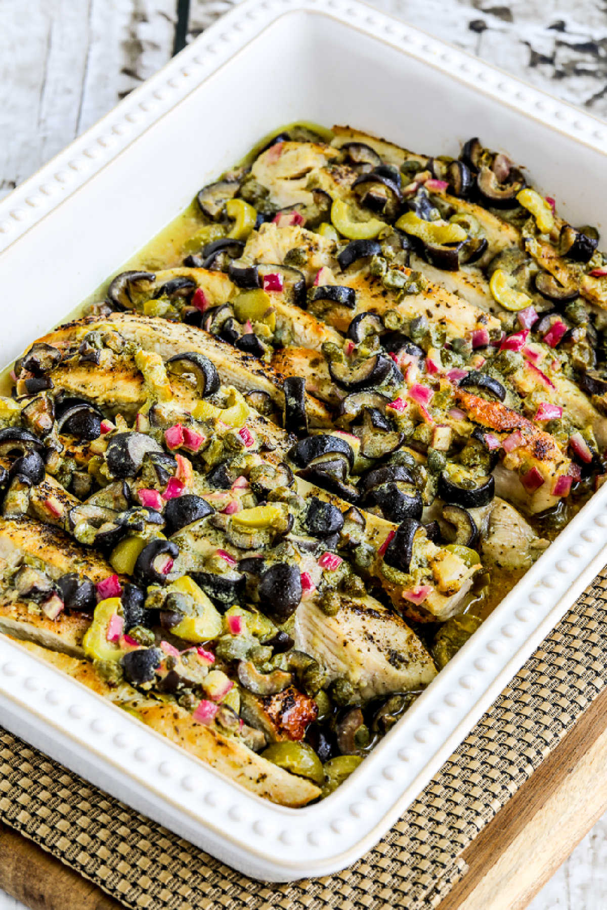 Chicken Bake with Olive and Caper Sauce shown in baking dish