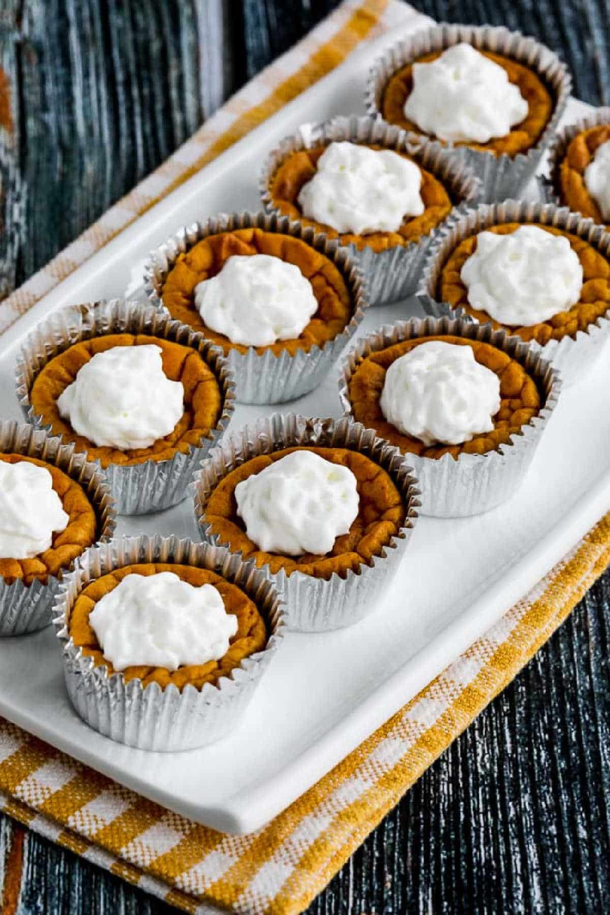 Mini Pumpkin Cheesecakes in foil cups on serving platter 