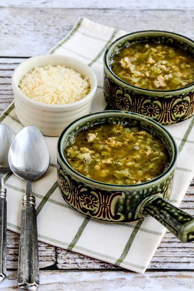 Instant Pot Turkey Rice Soup with Cabbage in two soup bowls with Parmesan