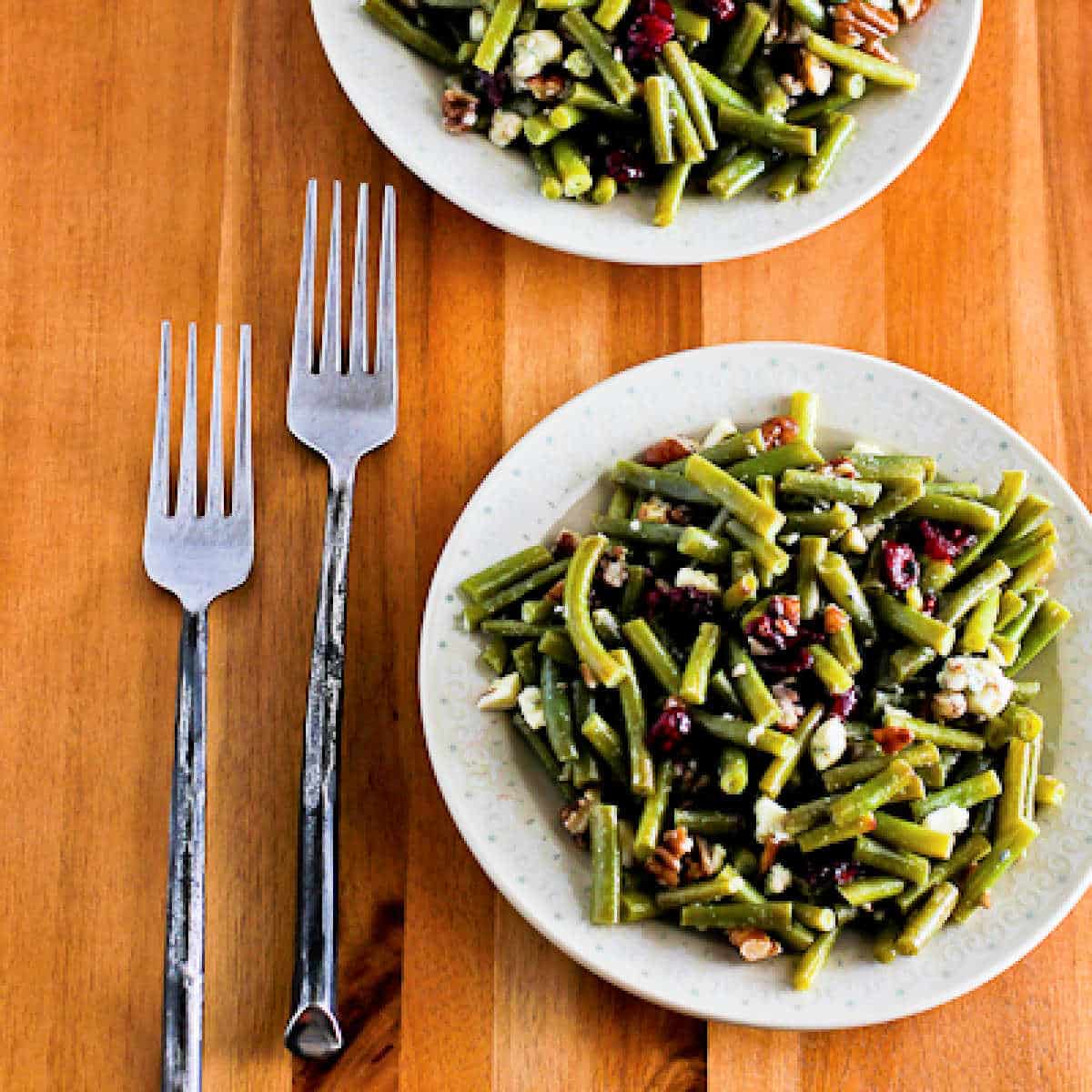 Square image for Thanksgiving Green Bean Salad shown on two plates with forks.