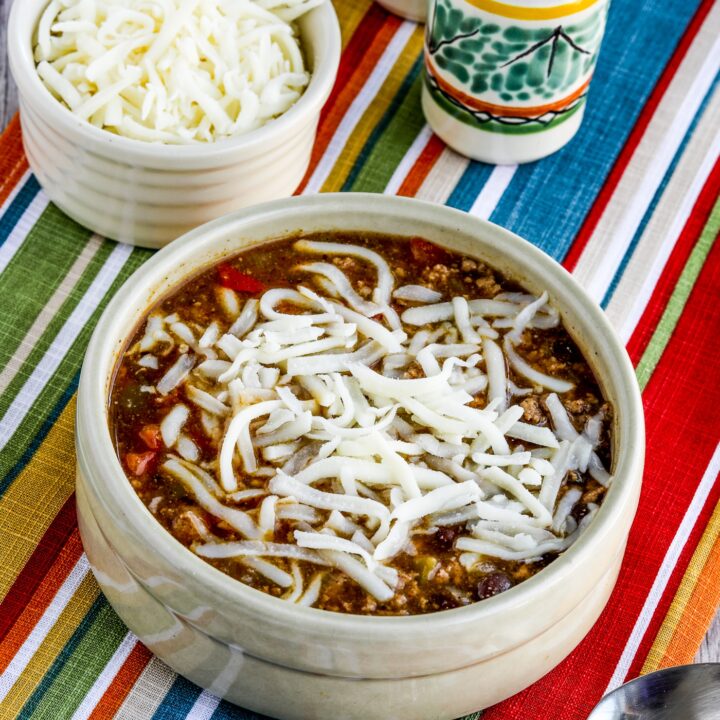 Green Chile Turkey Enchilada Soup finished soup in bowl with cheese.