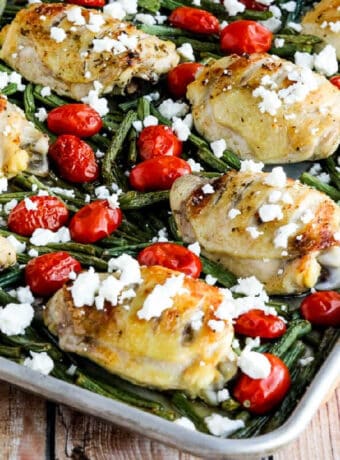 square image of Greek Chicken, Green Beans, and Tomatoes Sheet Pan Meal shown on sheet pan