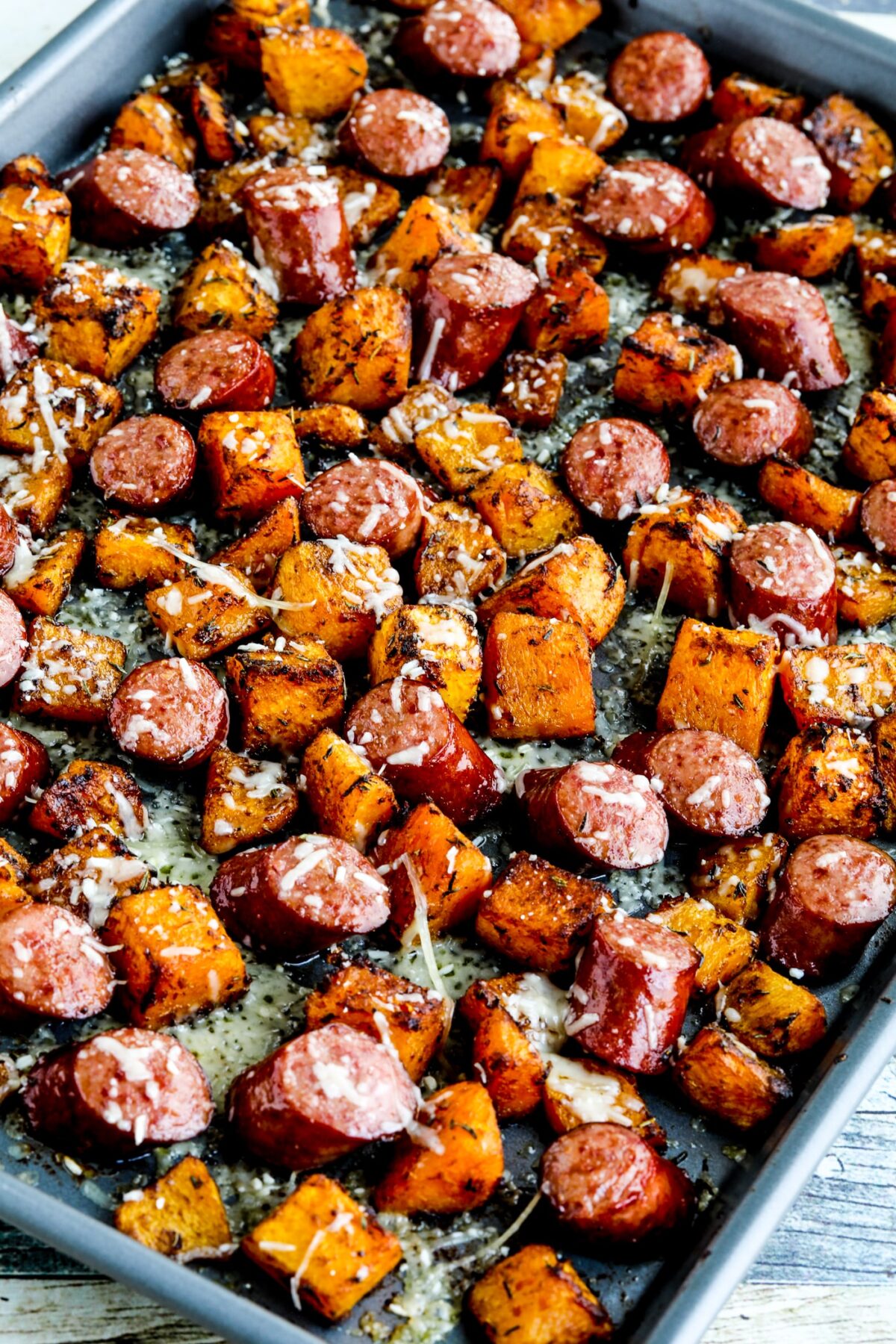Close-up of Roasted Butternut Squash and Sausage Sheet Pan Meal shown on sheet pan