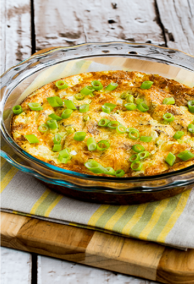 Cheesy Crustless Quiche Lorraine in baking dish on napkin and cutting board