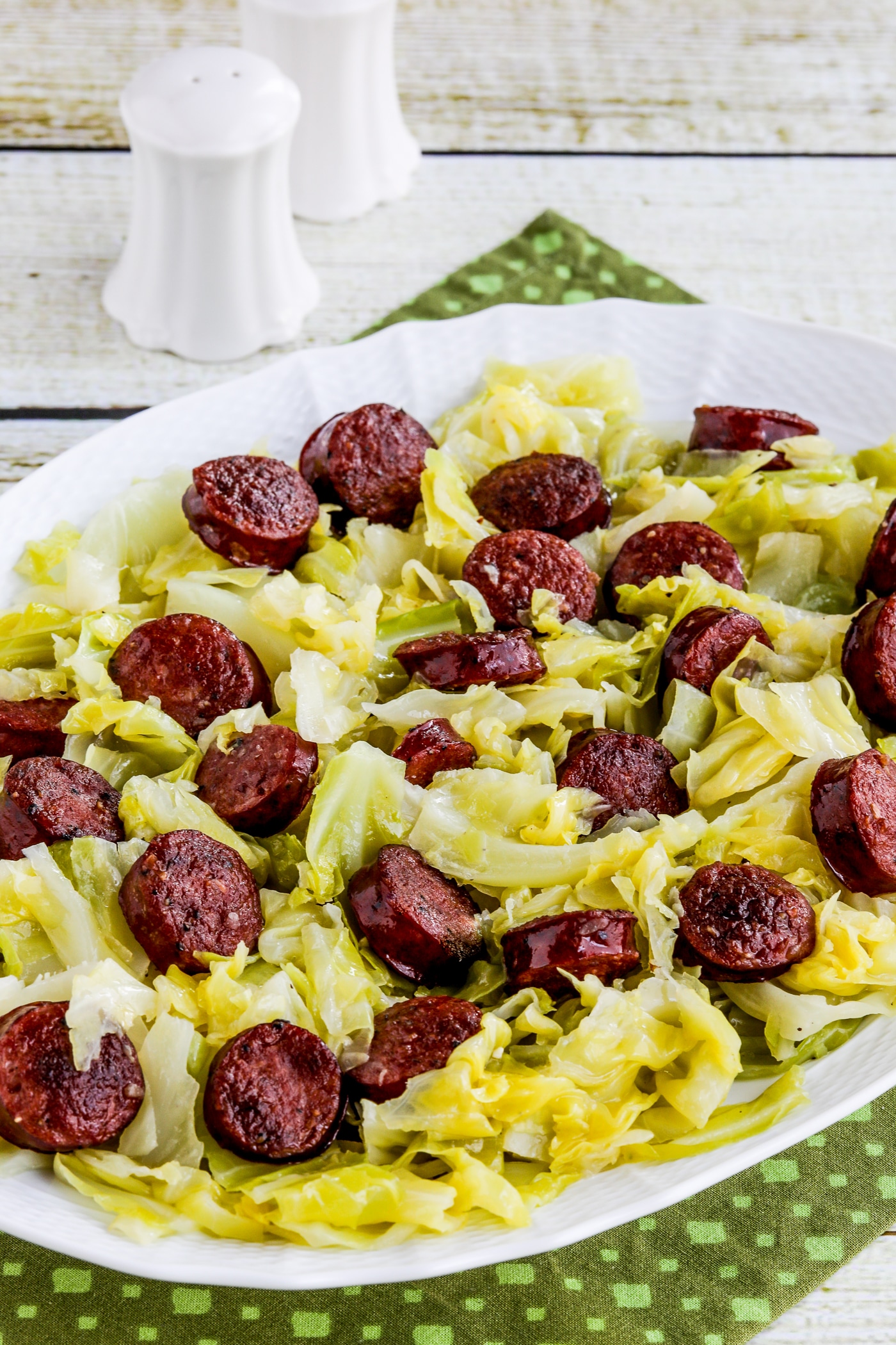 Finished dish of Instant Pot cabbage and sausage on a serving plate