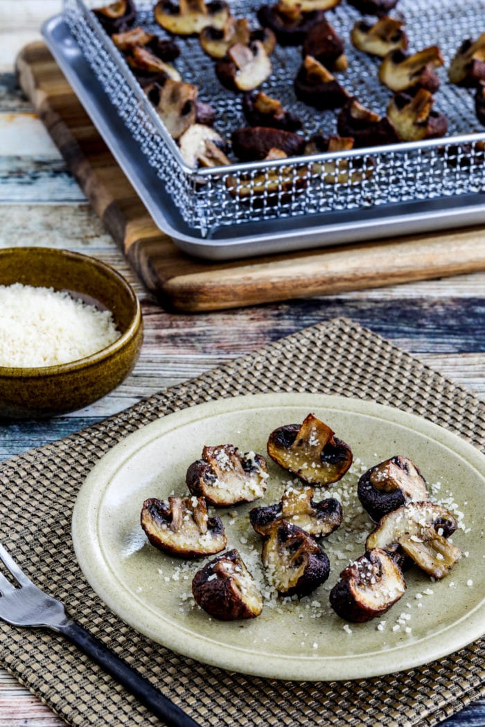 Air Fryer Roasted Mushrooms one serving of mushrooms on plate and some on air fryer rack