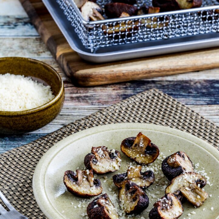 Air Fryer Roasted Mushrooms one serving of mushrooms on plate and some on air fryer rack