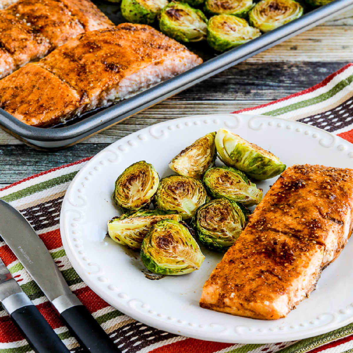 Square image of Brussels Sprouts Salmon Sheet Pan Meal shown on baking pan.