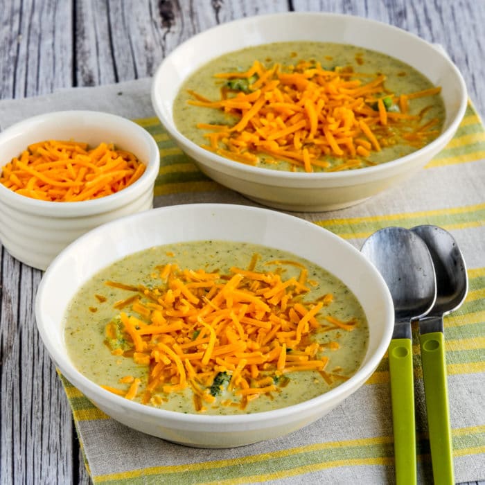 square image of Cheesy Broccoli and Cauliflower Soup in two serving bowls