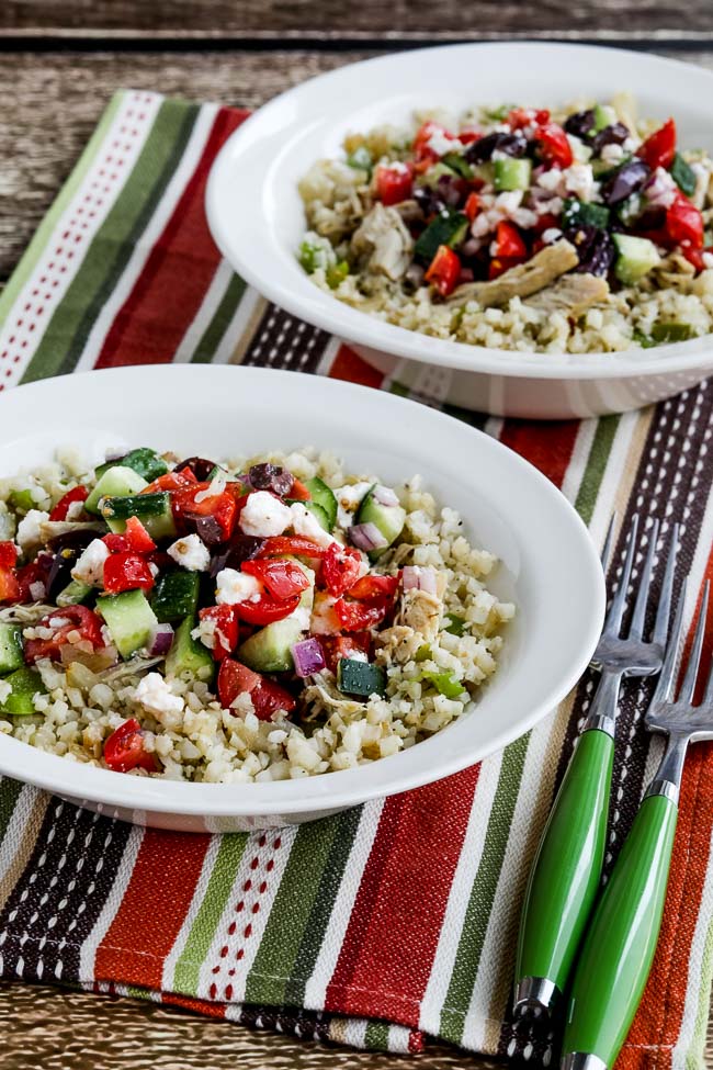 Instant Pot Cauliflower Rice Greek Chicken Bowls in two bowls with striped green and red napkin