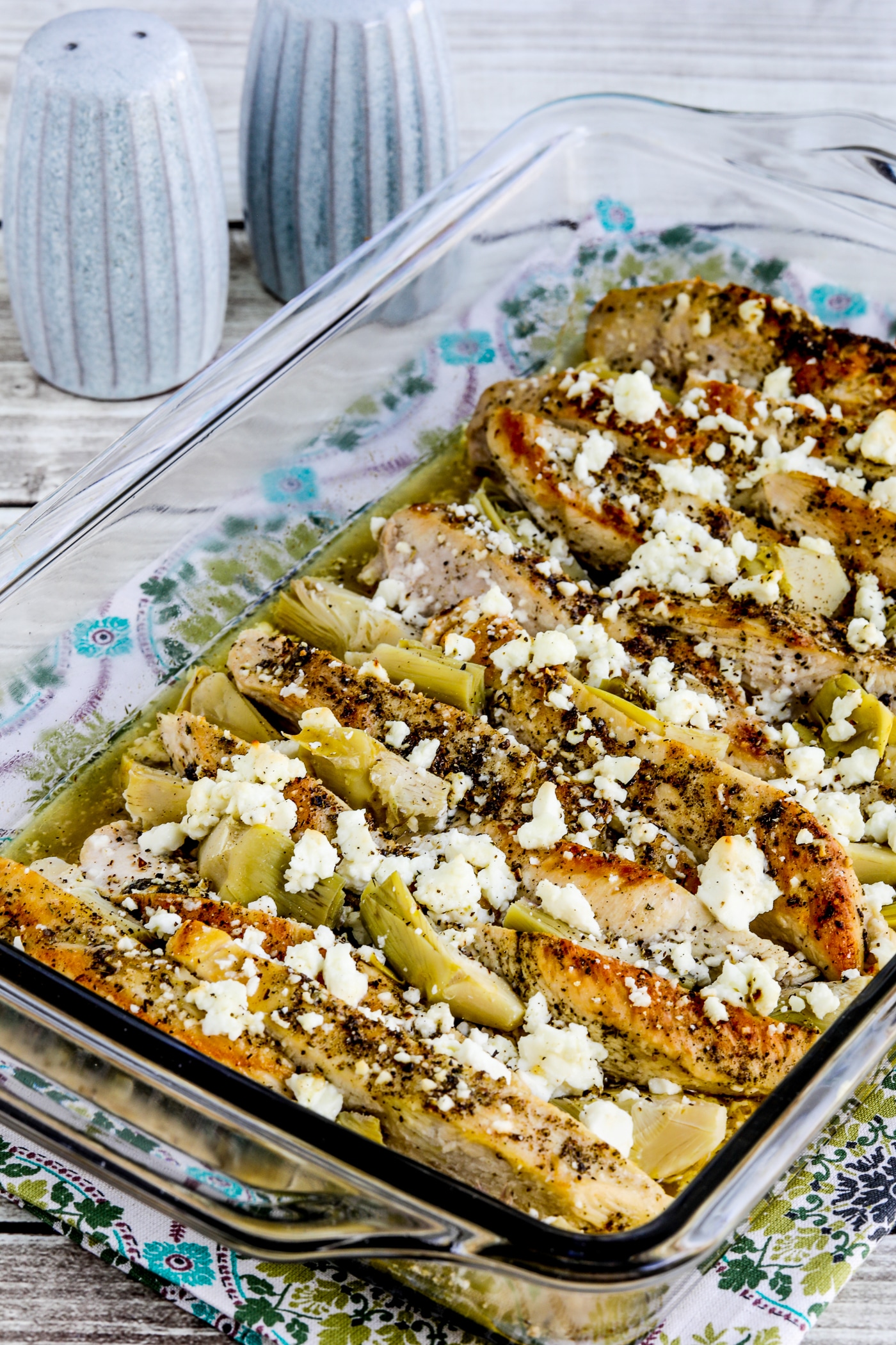 Artichoke Chicken Bake close-up photo of finished dish in baking pan