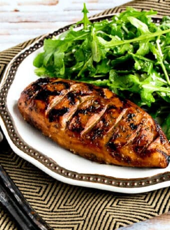 Grilled Chicken with Balsamic Vinegar shown on serving plate with arugula salad.