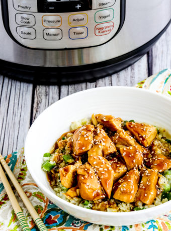 Instant Pot Teriyaki Chicken chicken in rice bowl with Instant Pot in back