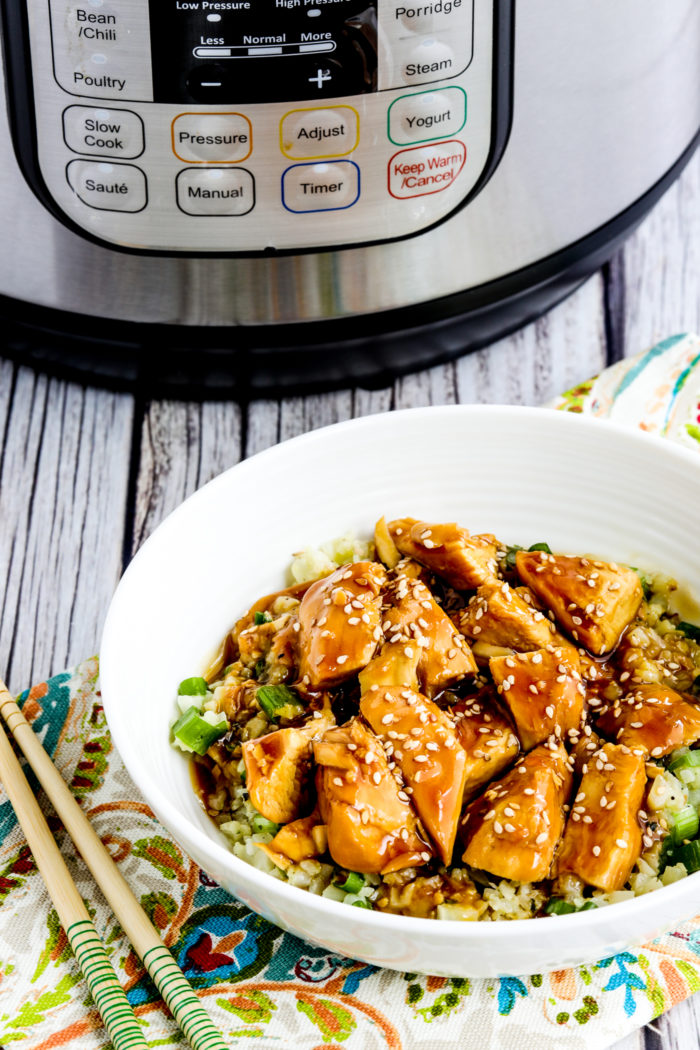 Instant Pot Teriyaki Chicken chicken in rice bowl with Instant Pot in back