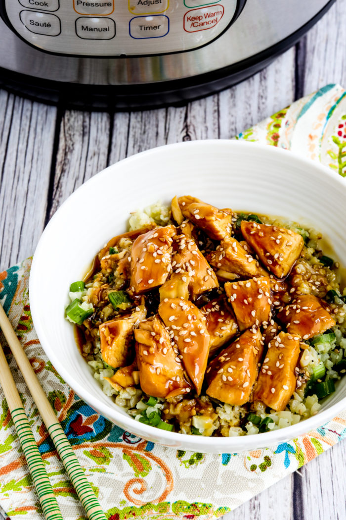 Instant Pot Teriyaki Chicken close-up of chicken in rice bowl with Instant Pot in back