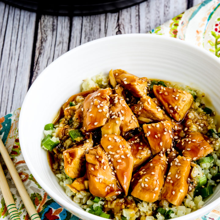 Instant Pot Teriyaki Chicken close-up of chicken in rice bowl with Instant Pot in back