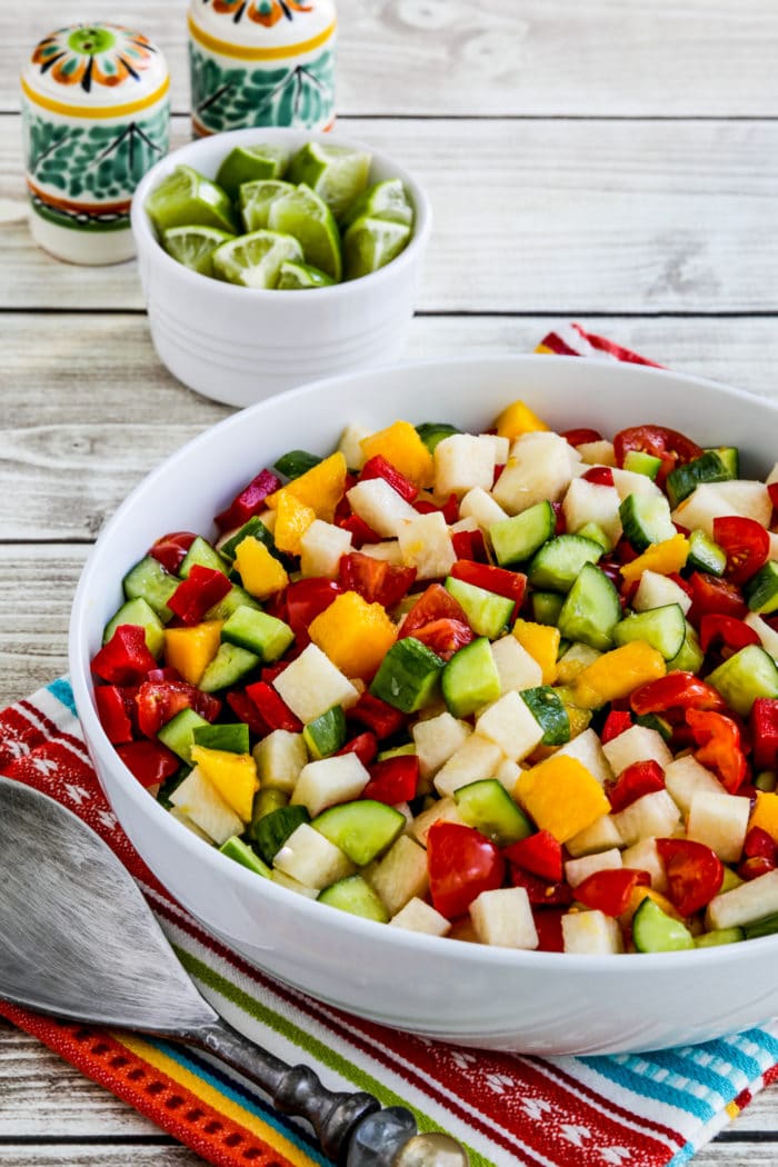 close-up photo of Laurel's Jicama Salad with limes and salt-pepper shakers in the background