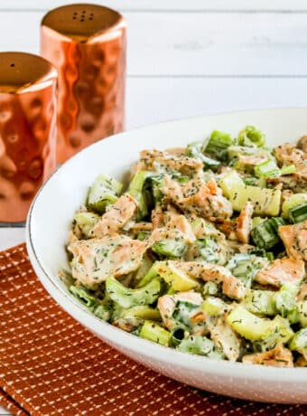 Salmon Salad with Dill in serving dish with salt and pepper shakers in back.