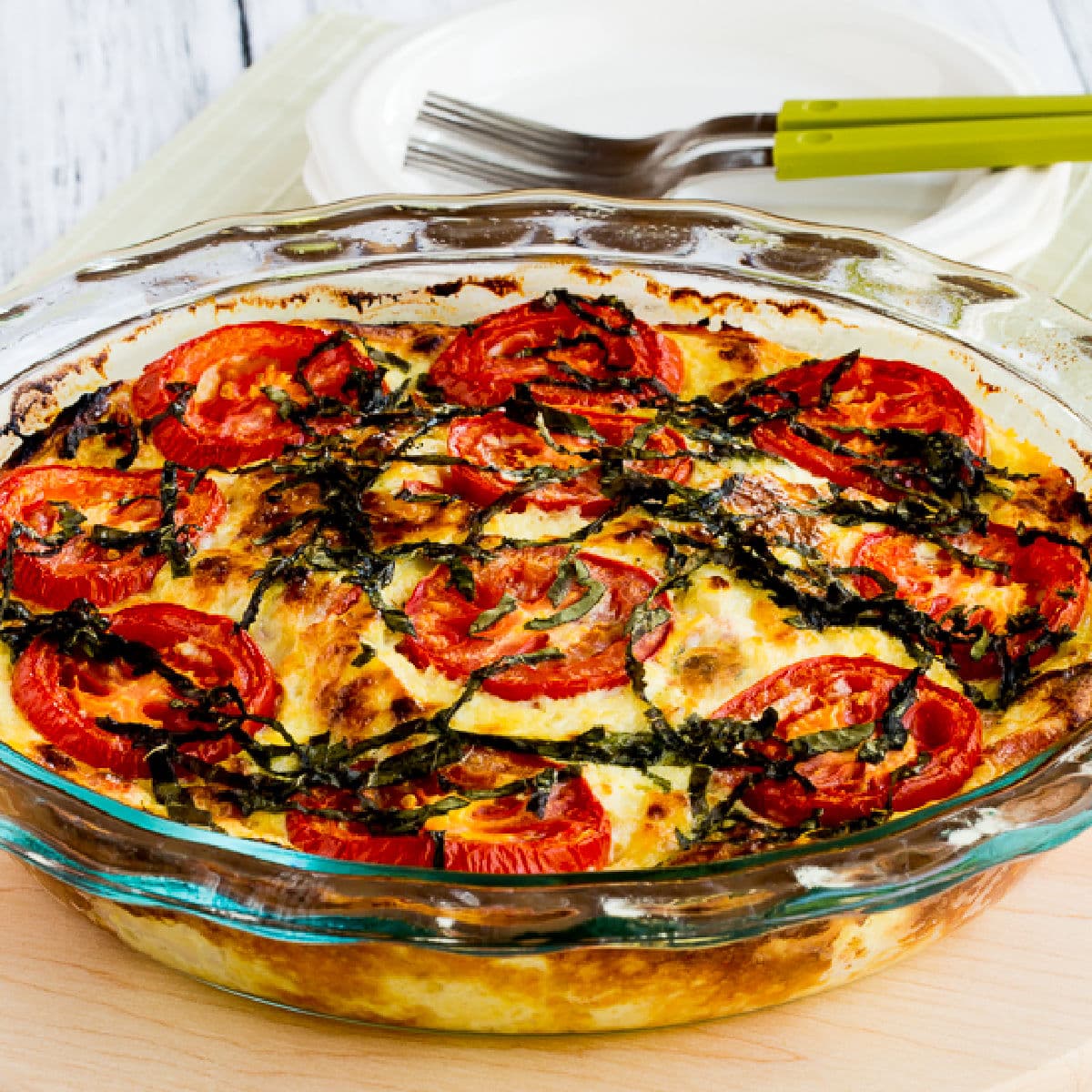 square image of Crustless Three-Cheese Tomato-Basil Quiche in baking dish