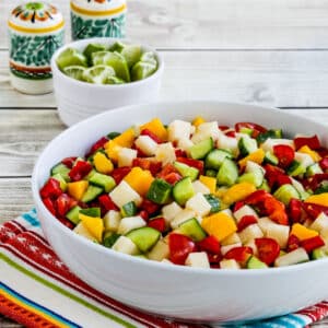 Laurel's Jicama Salad shown in serving bowl with limes and Mexican salt-pepper in back.