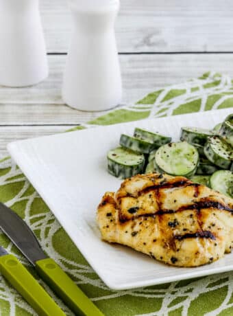 Grilled Cod with Garlic, Basil, and Lemon shown on plate with cucumber salad.