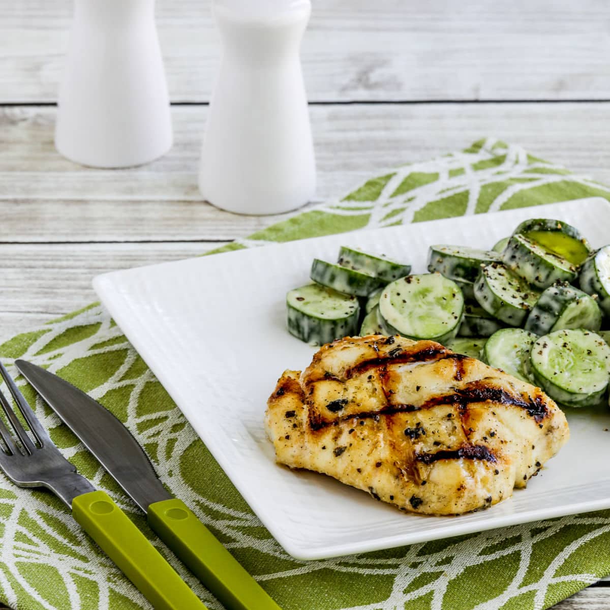 Grilled Cod with Garlic, Basil, and Lemon shown on plate with cucumber salad.
