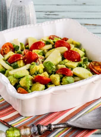 Heart of Palm Salad (with Tomato and Avocado) shown in serving bowl with fork.