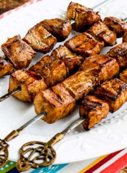 Square image of Chile Mustard Pork Kabobs shown on serving platter.