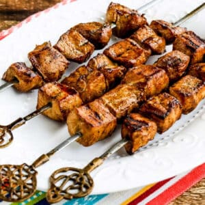 Square image of Chile Mustard Pork Kabobs shown on serving platter.
