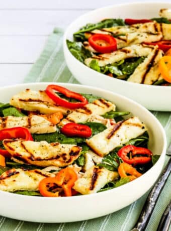 Grilled Halloumi Salad shown in two bowls on napkin.
