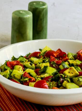 Square image for Tomato Salad with Cucumbers, Avocado, and Cilantro in white bowl.