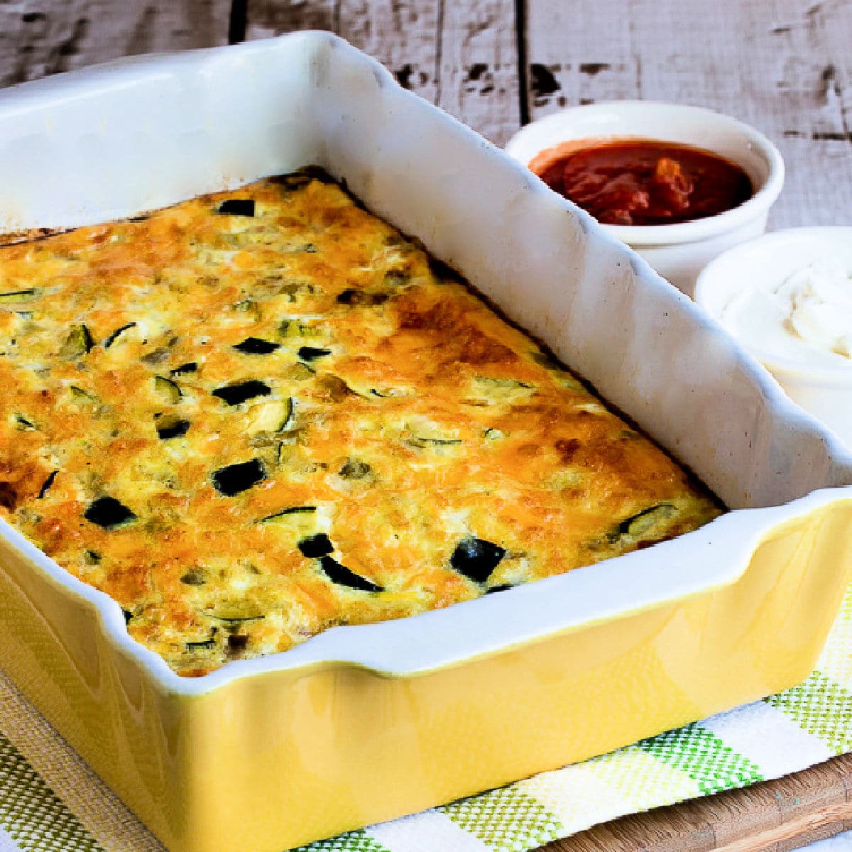 Square image of Zucchini Breakfast Casserole with Green Chiles in baking dish.