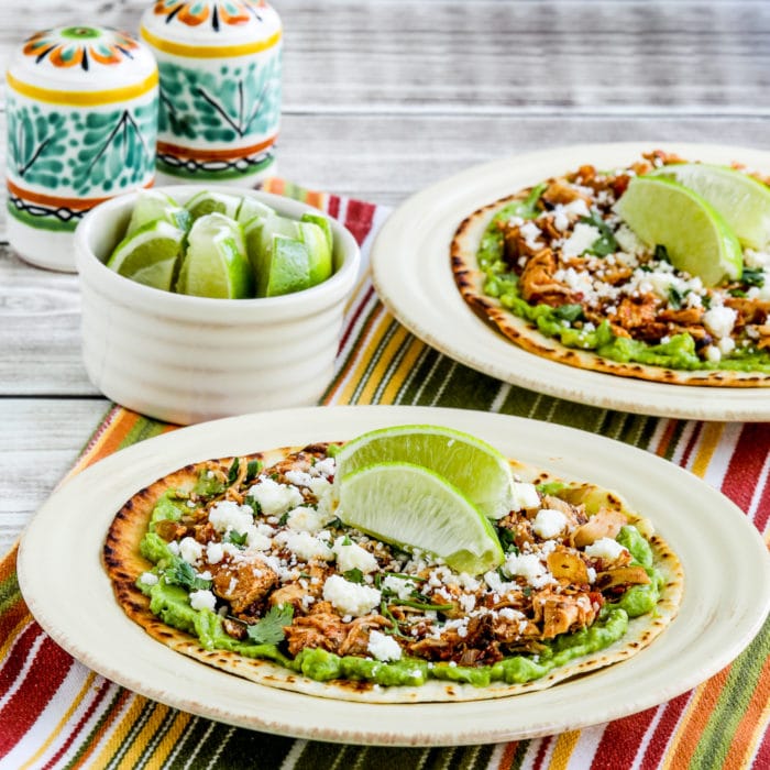 Instant Pot Chicken Tinga thumbnail image of tostadas on plate with limes