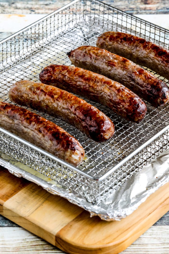 cooked Air Fryer Brats shown on air fryer rack