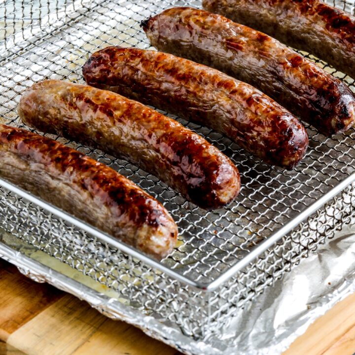 cooked Air Fryer Brats shown on air fryer rack