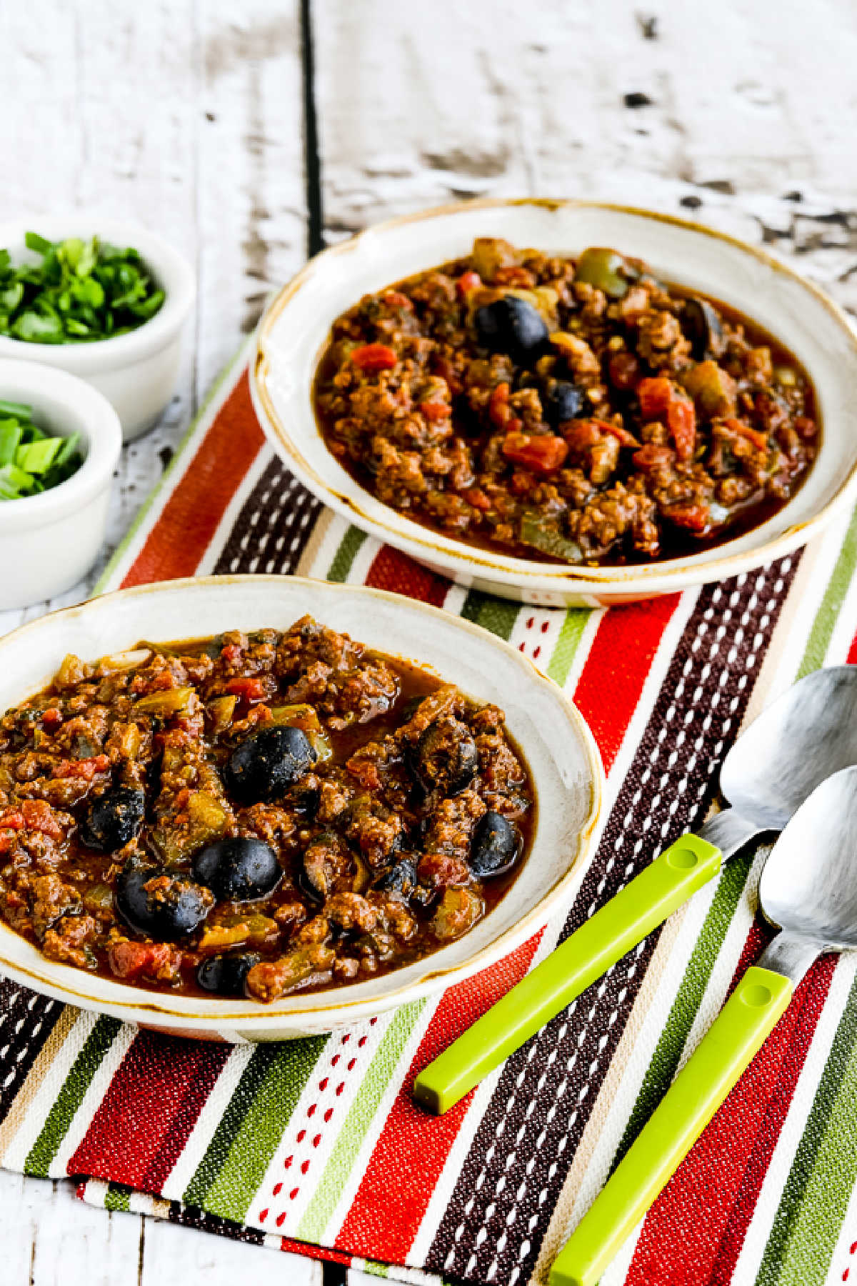 Pumpkin Chili with Beef, Peppers, and Olives in serving bowls