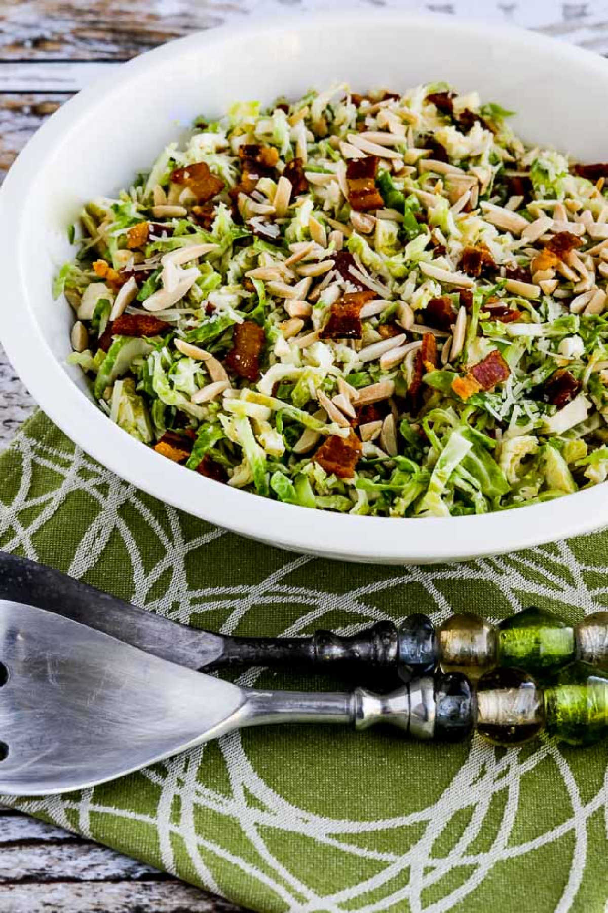 Brussels Sprouts Salad with Bacon, Almonds, and Parmesan shown in serving dish